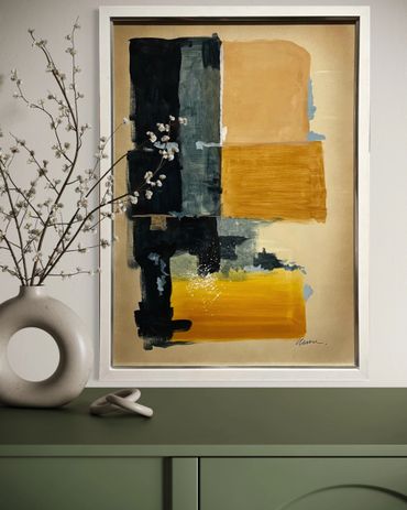 Abstract painting with mustard, black, and beige blocks above a green cabinet.
