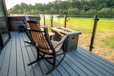 Crazy comfortable trex adirondack chairs in front of gas firepit on deck.