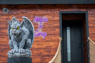 Gargoyle with lighted eyes patrolling the posts on way up cutom log-rope bridge.