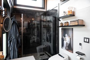Beautiful dark shower w/ glass door and wall. Electronic bidet/toilet.