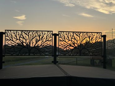 Tree of life on glass rails around hot tub.
