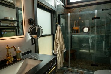 Luxurious bathroom w/ floating vanity, large format tile shower w/ amazing 10' high rainfall head.