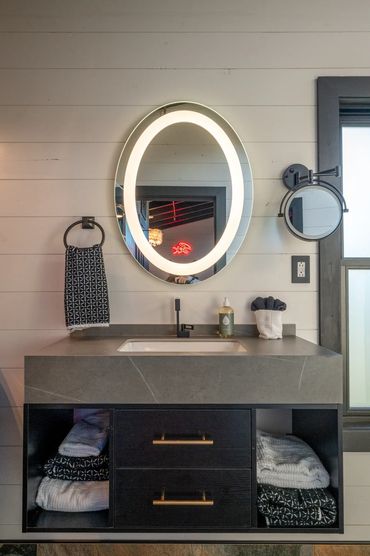 Modern floating vanity with LED mirror.