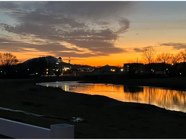 View of river at sunset with Sevierville courthouse.