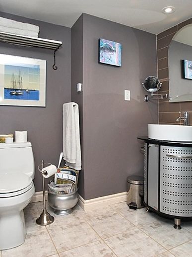 Bathroom mirror, glass shower, toilet, vanity painted walls