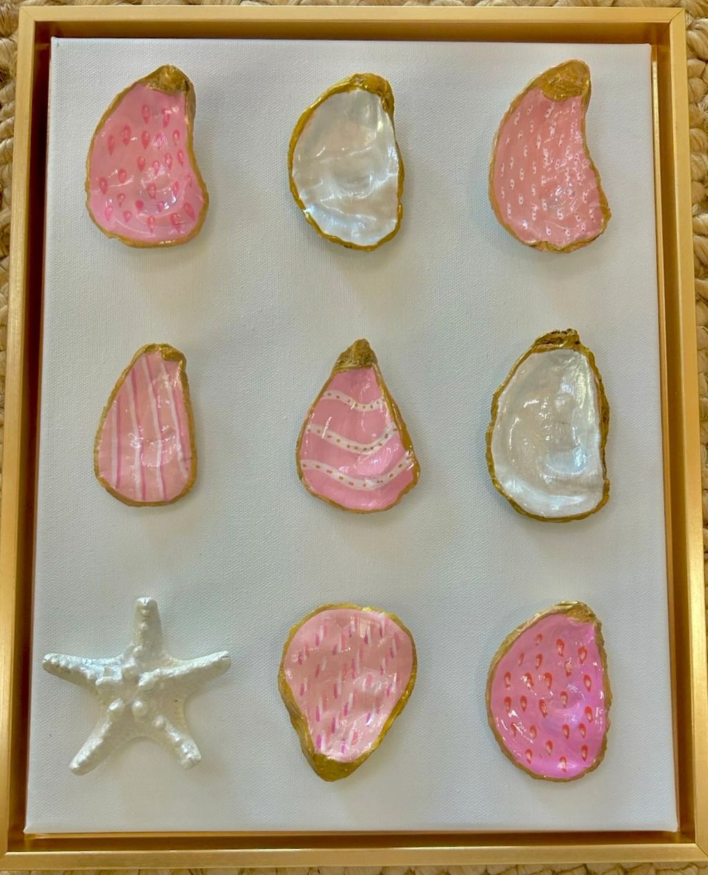 Hand-Painted oyster shells in pink, pearlized white and gold with pearl painted starfish.