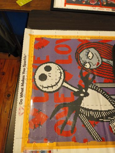 Diamond painting of Jack Skellington and Sally from The Nightmare Before Christmas.