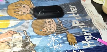 Diamond painting work in progress featuring cartoon characters and snowflakes.