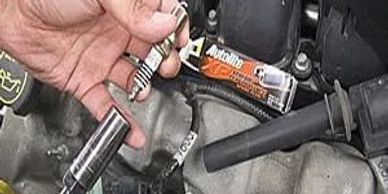 Person fixing a machine with his hand