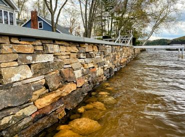 Stone retaining wall on lake in Holland, MA