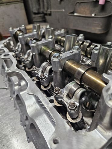 Close-up of an engine cylinder head showing camshaft and valve springs.