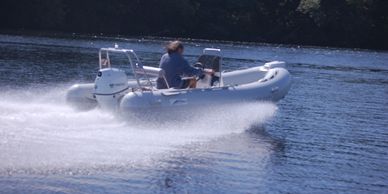 man on a white inflatable boat