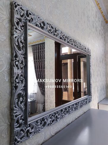 Ornate wall mirror with silver frame.