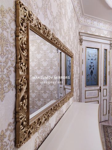 Elegant gold-framed mirror in a decorative room.