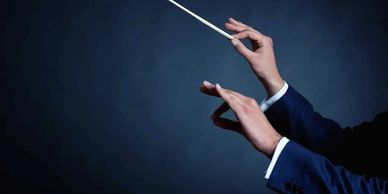 Conductor directing music with a baton.