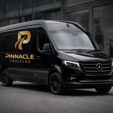 Black Mercedes van with Pinnacle Vehicles logo in gold on side.