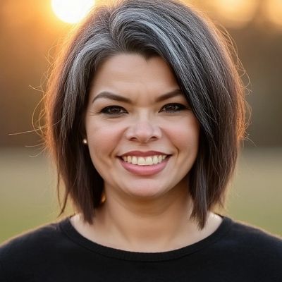 photo of Kristina Ramos, a smiling woman with short dark hair with gray highlights