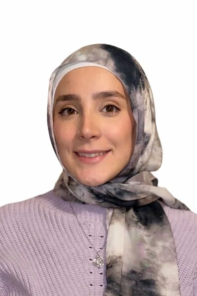 Smiling woman wearing a lavender sweater and scarf