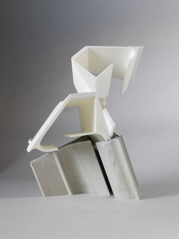 Abstract white sculpture on gray base.