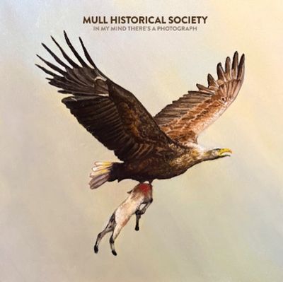 An eagle carrying a dead animal in flight, with text above it.