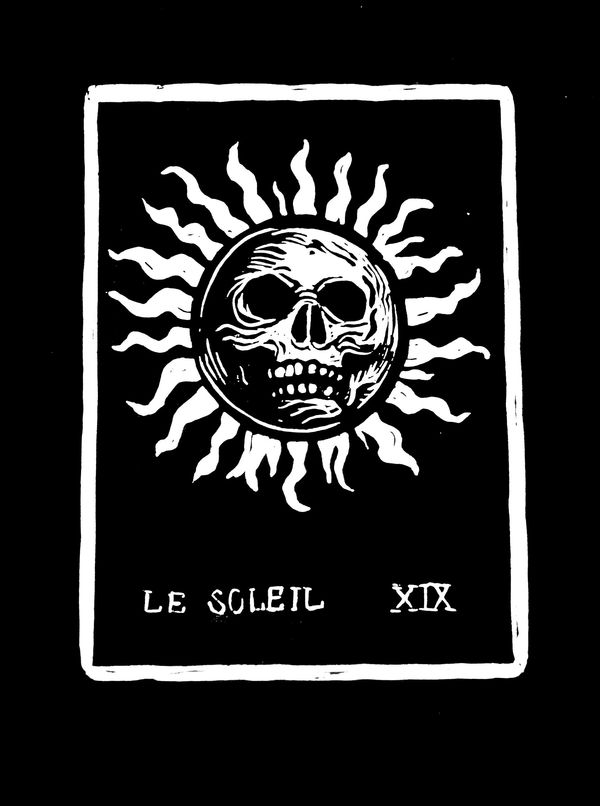Black and white tarot card with a sun and skull design.