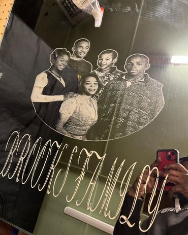 Engraved family portrait with "BROOKS FAMILY 29" text on reflective surface.