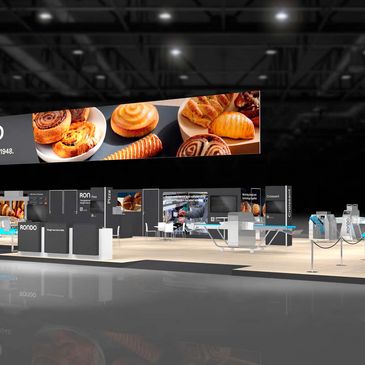 Modern exhibition booth with bakery-themed digital displays and sleek design.