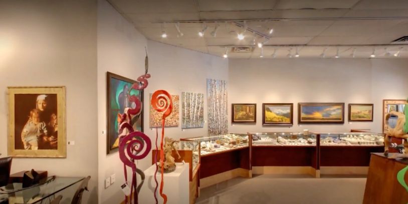 Art gallery with paintings and sculptures.
