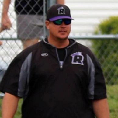 Man wearing sports attire and sunglasses outdoors.