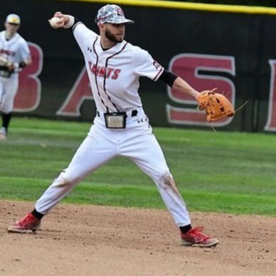 Baseball pitcher in action mid-throw.
