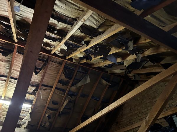 Torn tar paper roof lining, needs a new lining before spray foam insulation can be applied