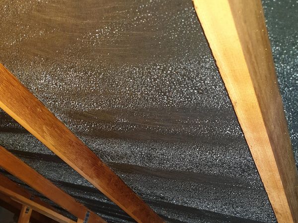 Condensation in a loft/attic dripping down the roof lining, caused by fibreglass insulation