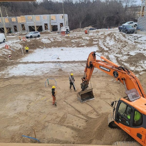 Excavator grading foundation dig
