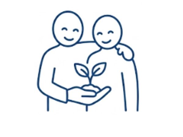 Two figures smiling, holding a small plant together.