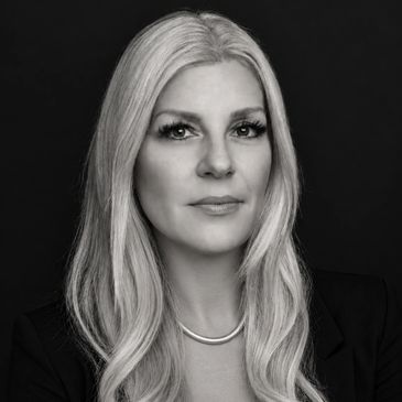Professional black and white portrait of a woman with long hair.