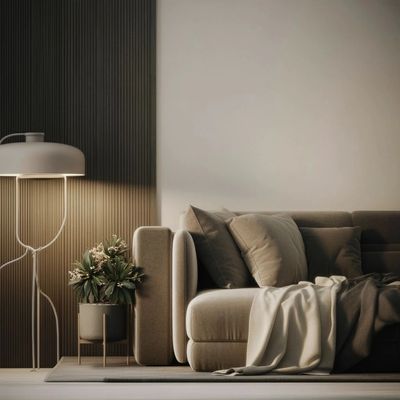 Cozy beige sofa with cushions and a throw blanket beside a floor lamp and potted plant.