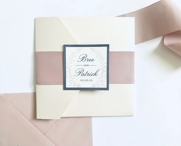 Elegant wedding invitation for Bree and Patrick with a soft pink ribbon and subtle floral design.