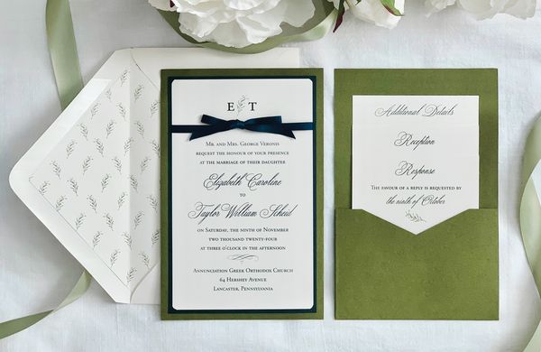 Elegant olive green wedding invitation set with floral accents and navy blue ribbon.