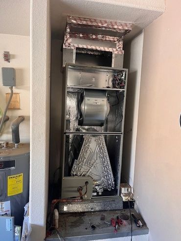 Open HVAC unit revealing internal components and ductwork.