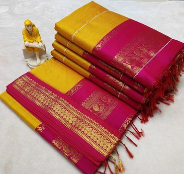 Bright yellow and pink silk sarees with intricate gold borders and a small figurine.