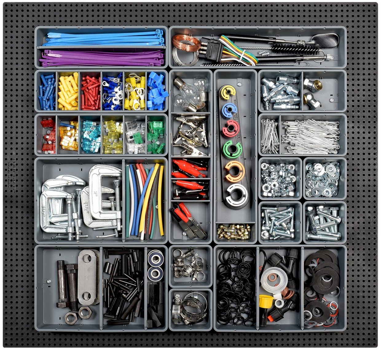 tool grid containers filled with random pieces on a tool grid board