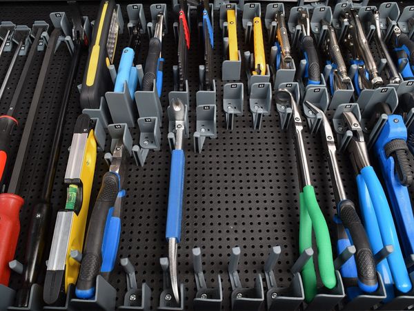 more pliers in the tool grid system on a tool grid board, some holders left empty