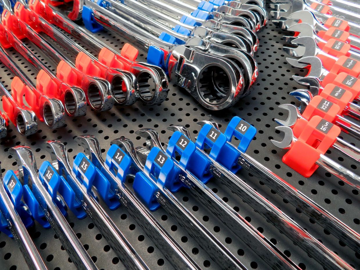 close up of wrenches in tool grid holders on a tool grid board