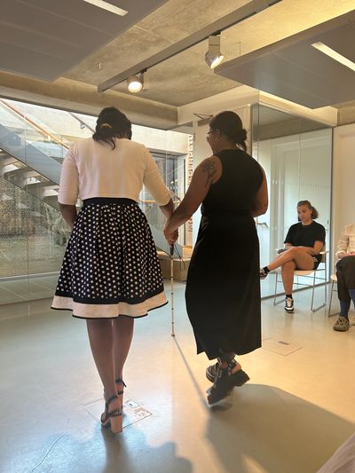 Ramona training a participant on how to guide someone living with sight loss. Sight loss workshop