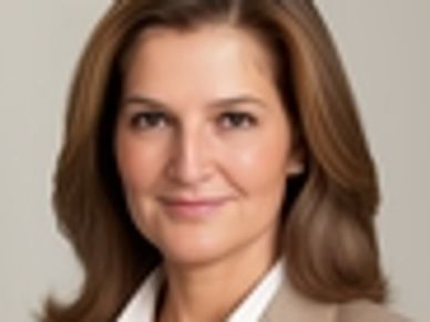 Professional woman with light brown hair smiling.
