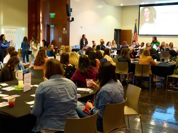 A large group of people attending a seminar in a conference room.