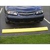 A car is parked behind a yellow parking curb in an outdoor parking space.