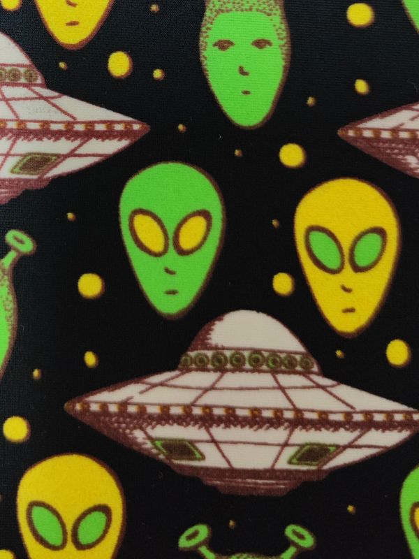 An alien print on black fabric.