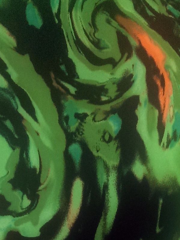 A green storm print on black fabric.