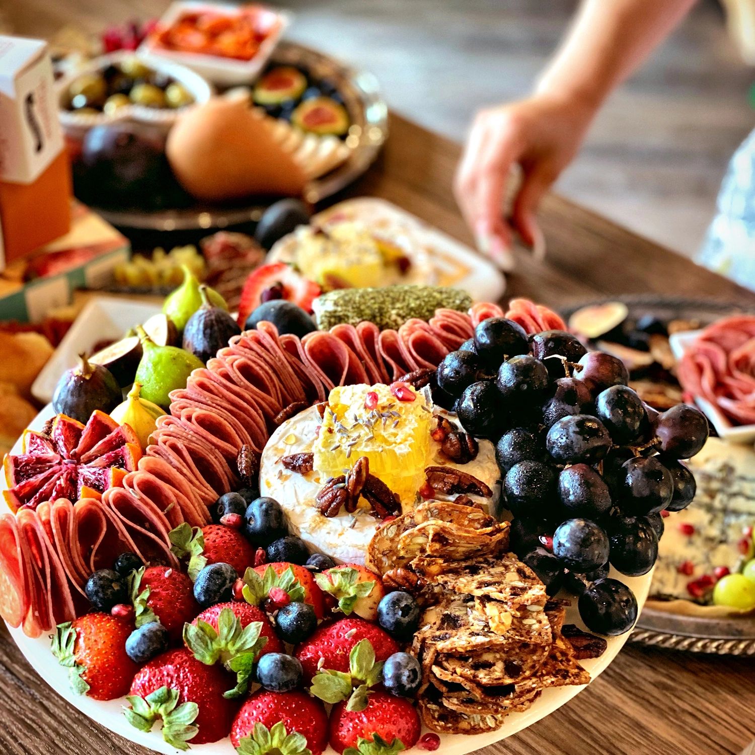 Charcuterie Board Display with an assortment of Meat, Cheese, and Fruit.